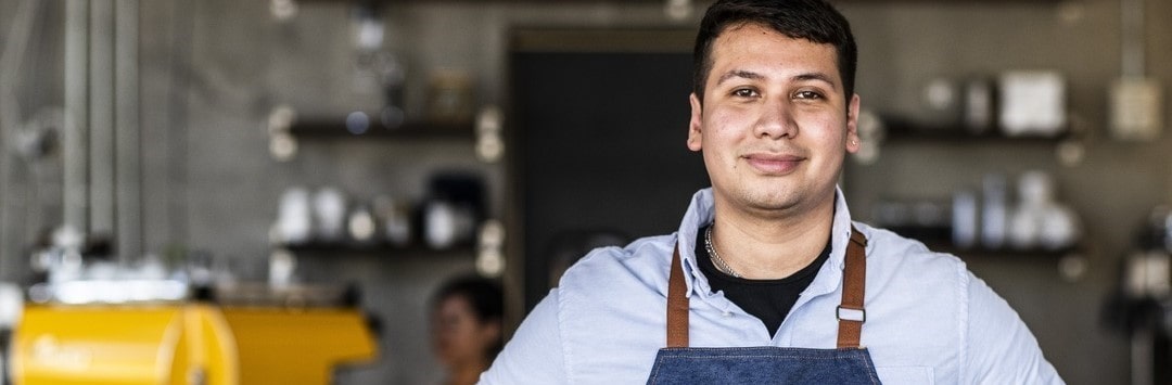 Smiling man at work in a kitchen